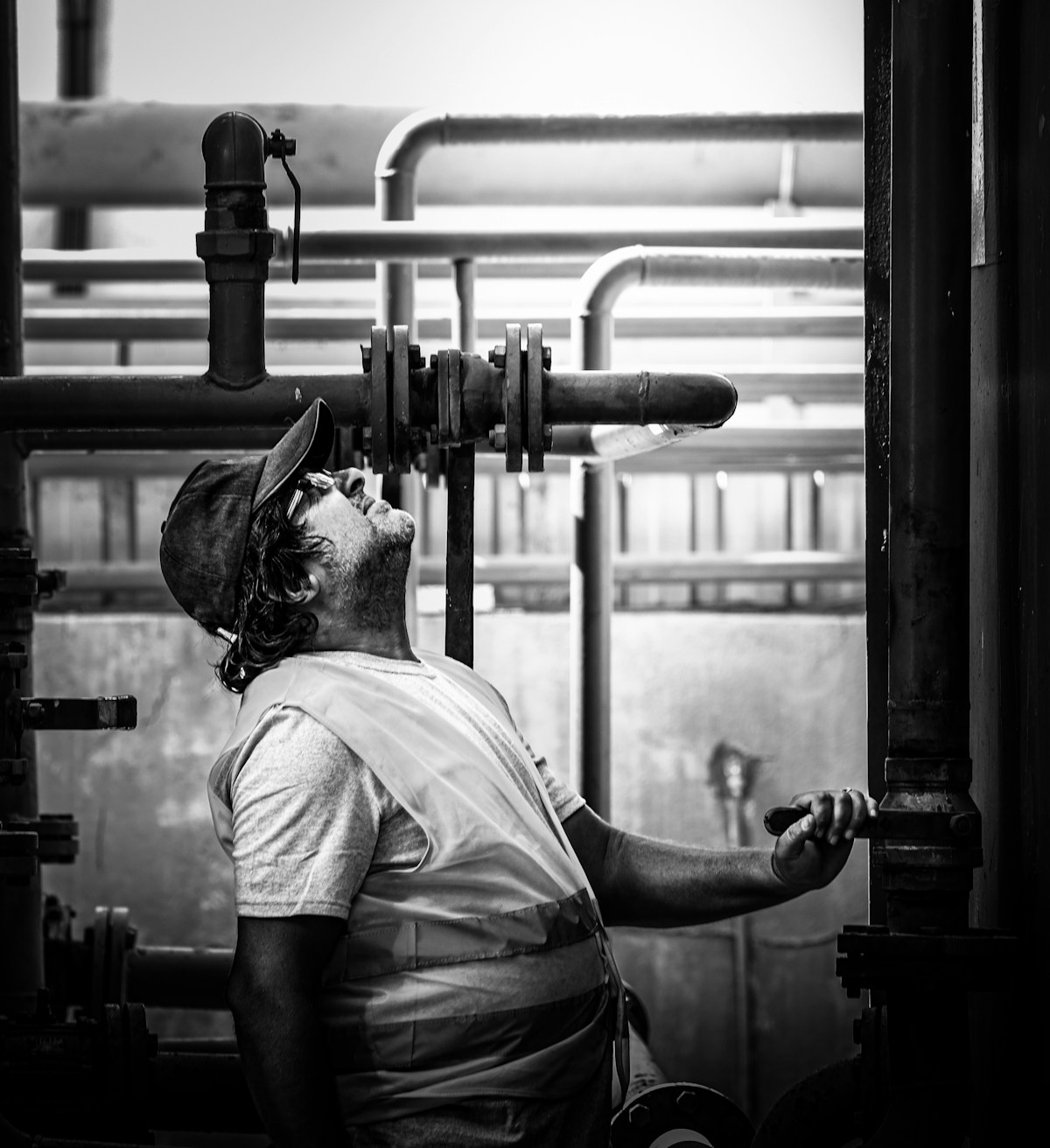 Technician inspecting commercial heating and mechanical piping